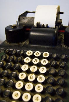 Photo of an old adding machine by Boise, ID photographer Benjamin Earwicker.  Oh, my aching fingers...